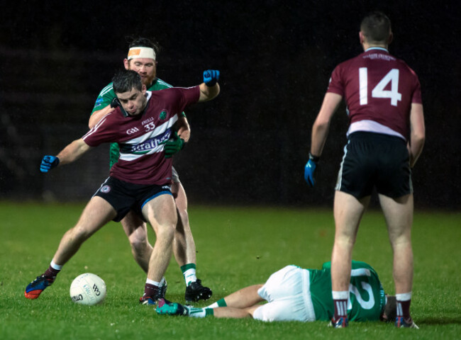 Patrick McBride under pressure as James McMahon lies injured