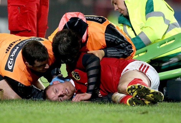Keith Earls down injured after been tackled from Luke Fitzgerald and Zane Kirchner