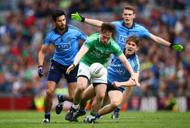 Tomas Corrigan under pressure from Cian O&Otilde;Sullivan and Michael Fitzsimons