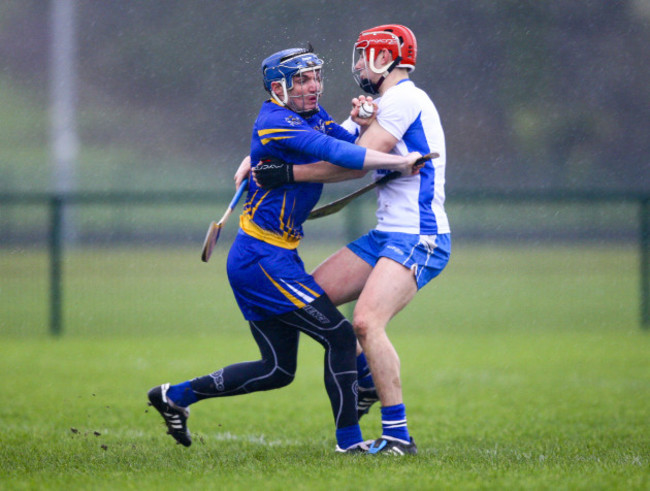 Donal Tuohy is tackled by Seamus Keating