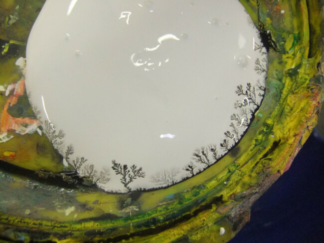 The residue of black paint mixed with my white paint and made a little forest.