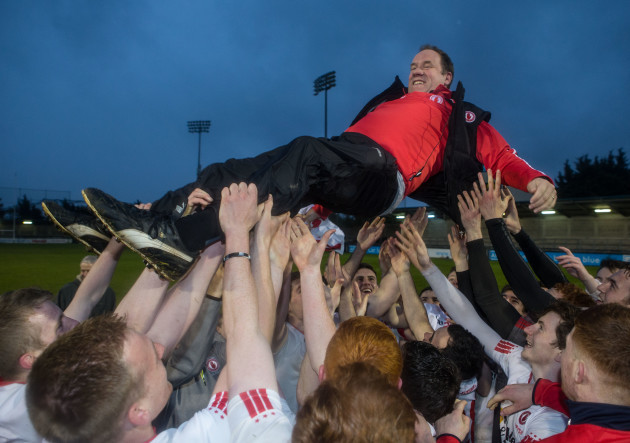 Tyrone players celebrate with Feargal Logan