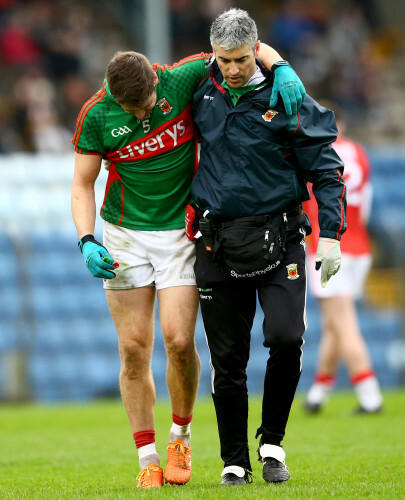 Lee Keegan is helped from the field by Dr. Sean Moffatt