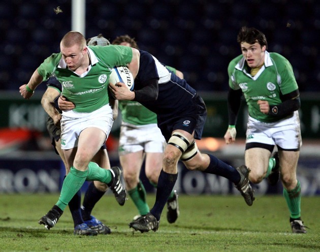 Keith Earls supported by Shane Monahan gets tackled by the Scottish defence