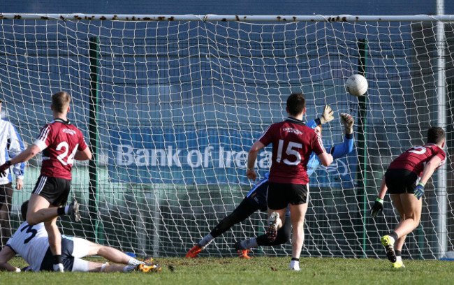 Ryan McNulty shoots past UUJ goalkeeper Sean Fox to score a goal