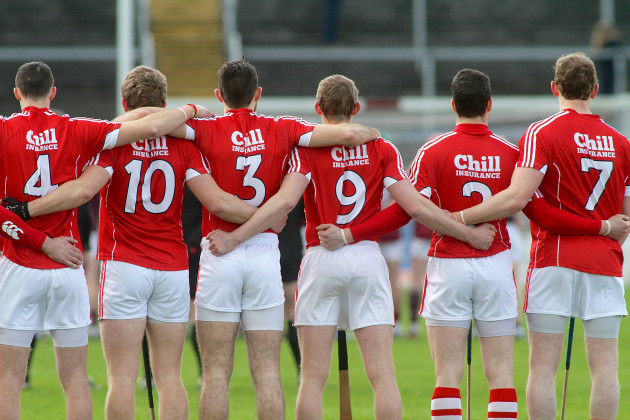 The Cork players stand for the National Anthem