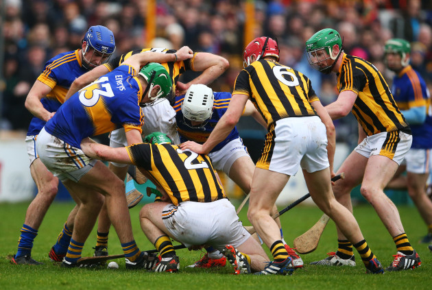 Kilkenny and Tipperary players search for a loose ball