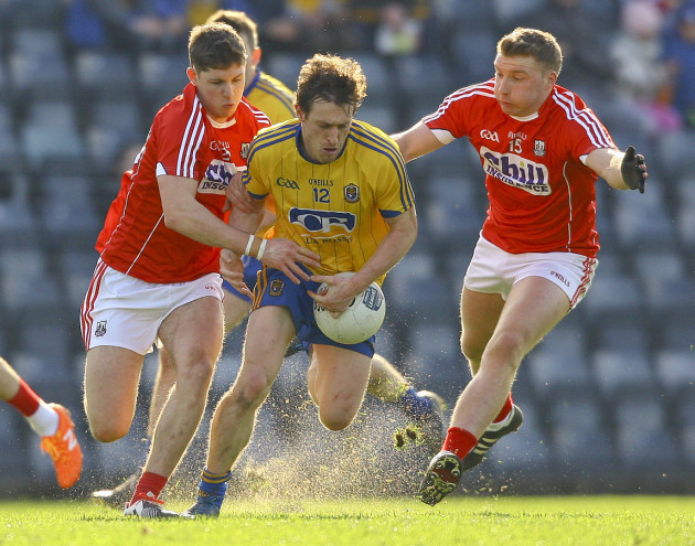 Conor Devaney is tackled by Kevin Crowley and Brian Hurley