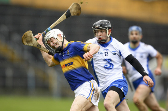 Michael Cahill is tackled by Mikey Kearney