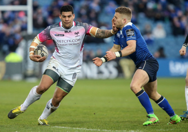 Ian Madigan is handed off by Josh Matavesi