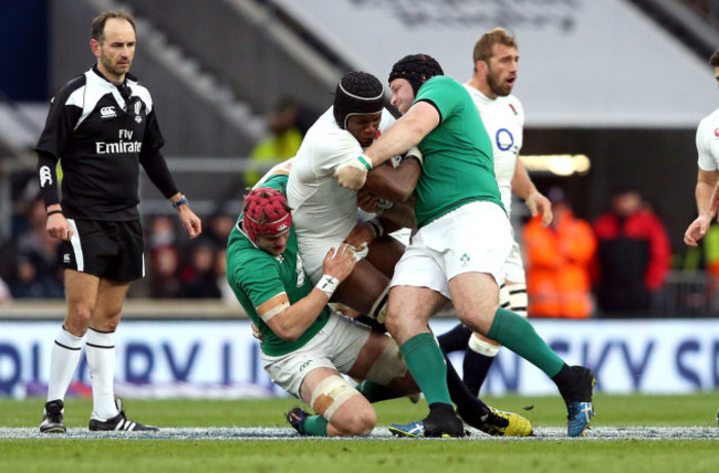 Maro Itoje tackled by Josh van der Flier and Mike Ross