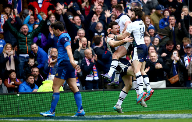Stuart Hogg and Tommy Seymour celebrate with try scorer Duncan Taylor