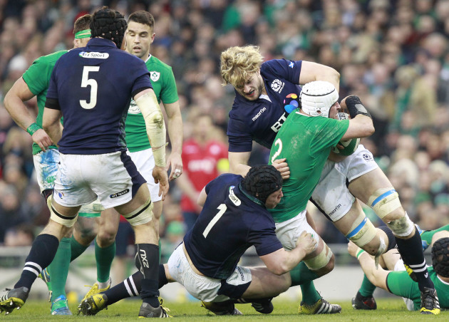 Rory Best is tackled by Alastair Dickinson and Richie Gray