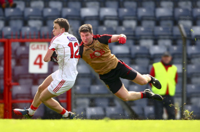 Mark Collins is tackled by Peter Turley