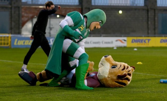 The two team mascots joke around before the game