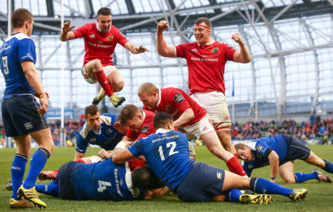 Conor Murray and Robin Copeland celebrate as Johnny Holland scores his sides first try