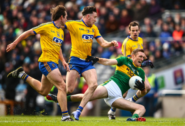 Brendan O’Sullivan is tackled by David Kennan and Neil Collins