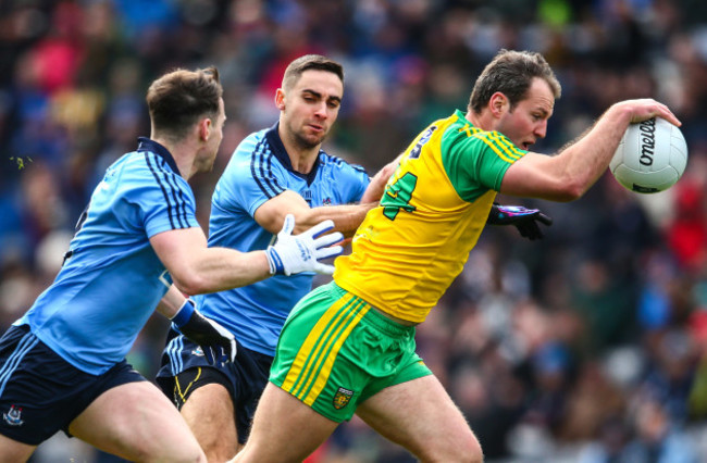 Philip McMahon and James McCarthy tackle Michael Murphy