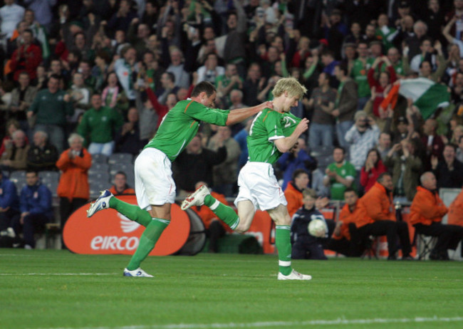 Andy Keogh runs off celebrating his goal followed by Damien Delaney