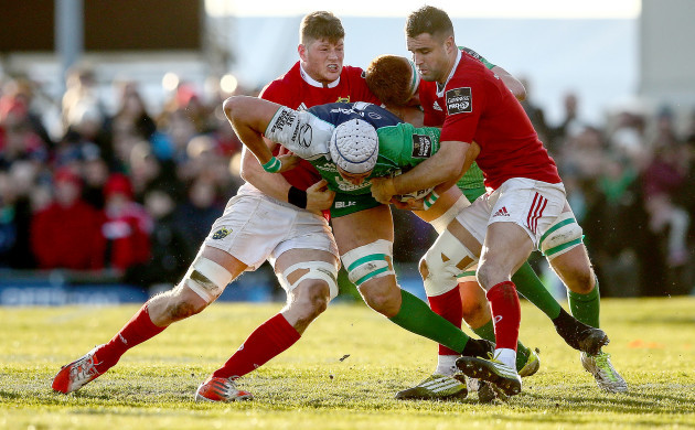 Ultan Dillane tackled by Jack O'Donoghue and Conor Murray