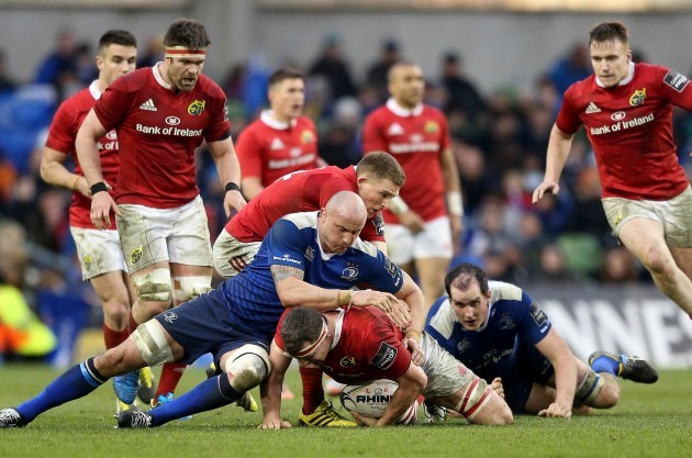 Munster’s Robin Copeland is tackled by Leinster’s Hayden Triggs