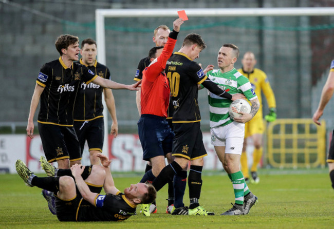 Neil Doyle shows Gary McCabe a red card