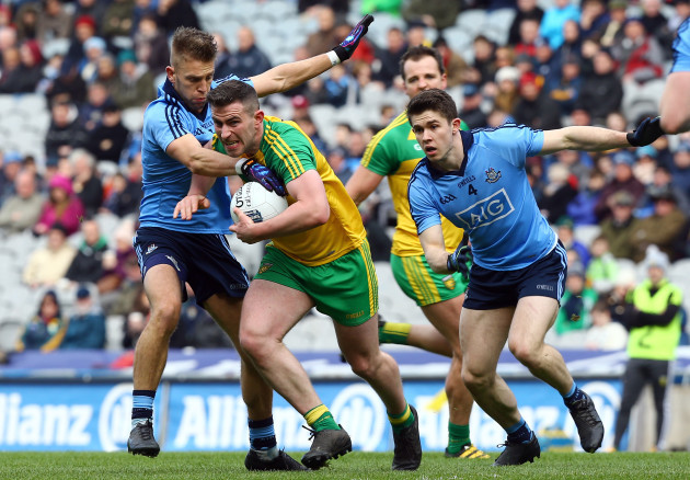Patrick McBrearty is tackled by Paul Mannion