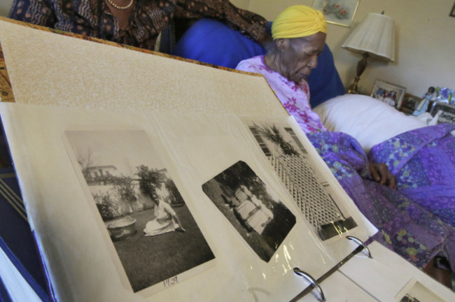 Susannah and her photo album, pictured in her room last June.