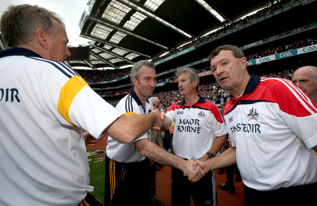 Cork and Tipperary Management teams shake hands after the game