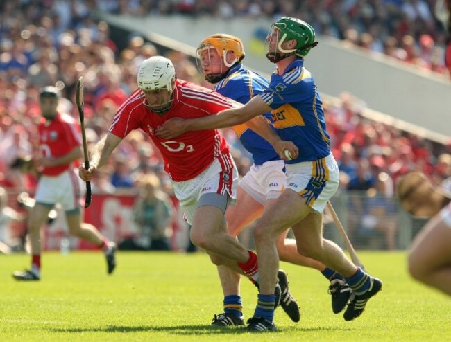 Seamus Callanan and Declan Fanning tackle Timmy McCarthy