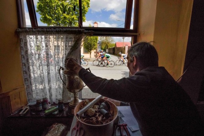 Dan O'Connor watches from the window of John D's Bar in Ballydesmond as the riders of the An Post Rás pass by