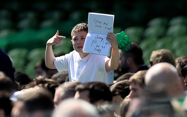 A young supporter holds up a sign