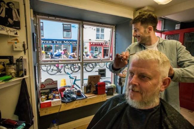 Mike Murphy has his hair cut by Owen Crudge as the An Post Rás finishes in Clonakilty