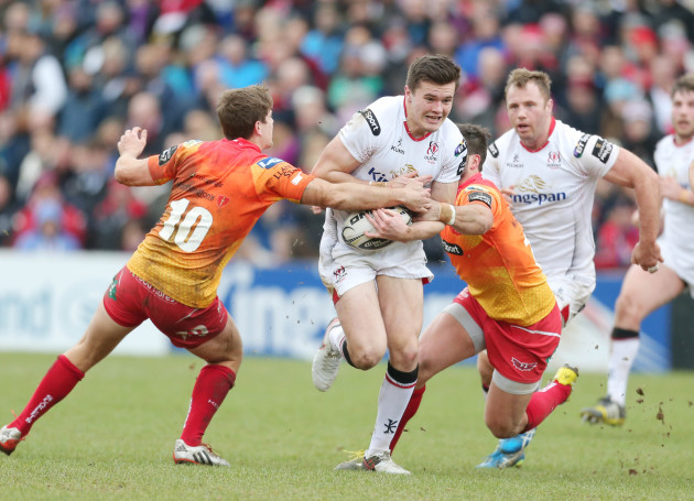 Jacob Stockdale is tackled by Aled Thomas and Gareth Owen
