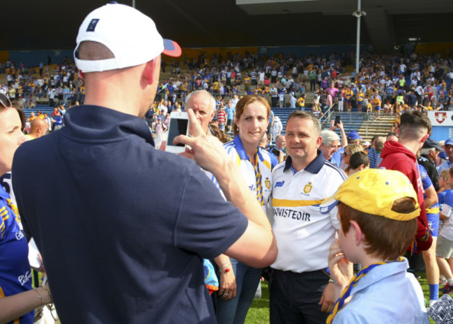 Davy Fitzgerald takes a picture with fans at the end of the game