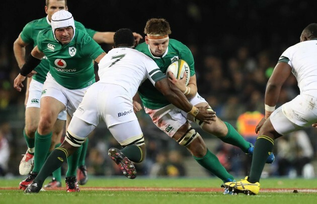 Iain Henderson is tackled by Siya Kolisi