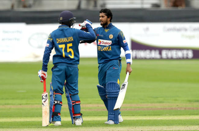 Dinesh Chandimal celebrates hitting a century with Dananjaya de Silva