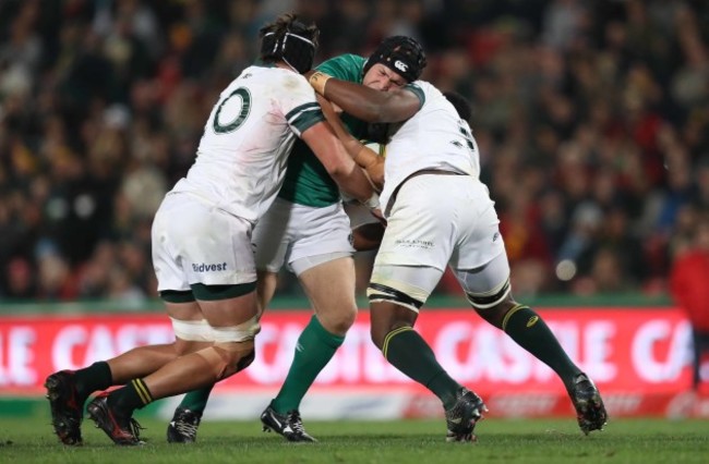 Ireland’s Richardt Strauss is tackled by/ Springboks Warren Whiteley and Siya Kolisi