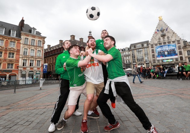 Irish fans play football in the Grand Place