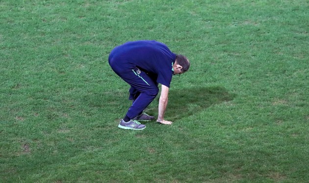Martin O'Neill checks on the playing surface