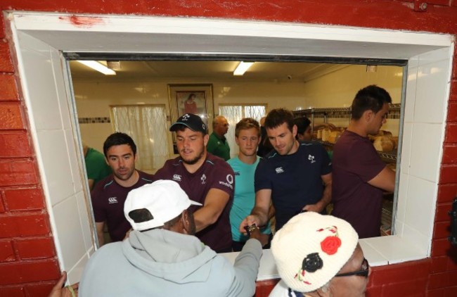 Vinny Hammond, Sean Reidy, Kieran Marmion and Jared Payne give out food