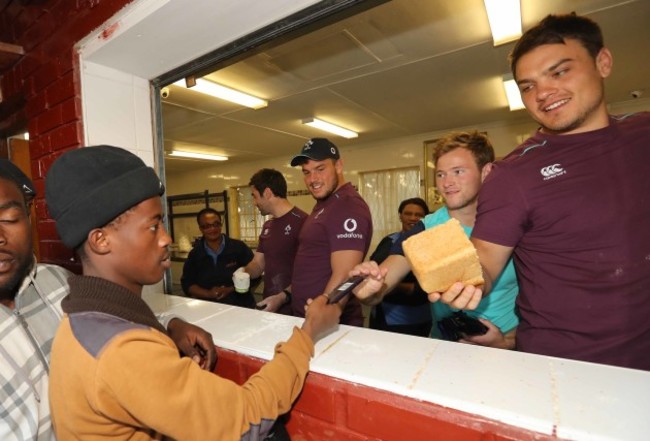Vinny Hammond, Sean Reidy, Kieran Marmion and Quinn Roux give out food
