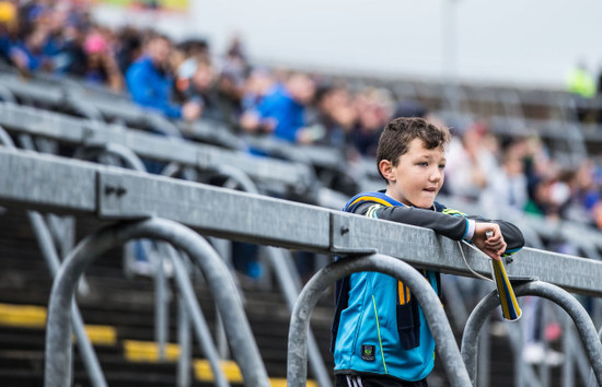 A young Tipperary supporter awaits the arrival of the teams