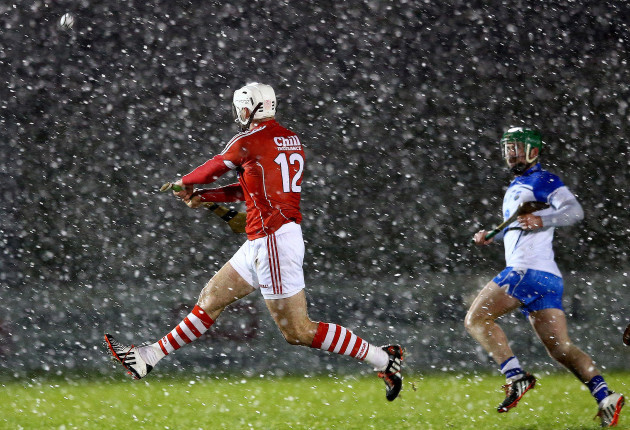 Patrick Cronin gets a shot away as snow falls