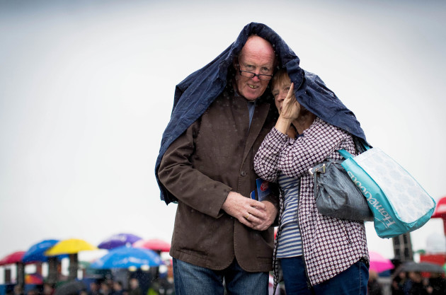 Gerry and Marian Hughes attempt to stay dry during a shower