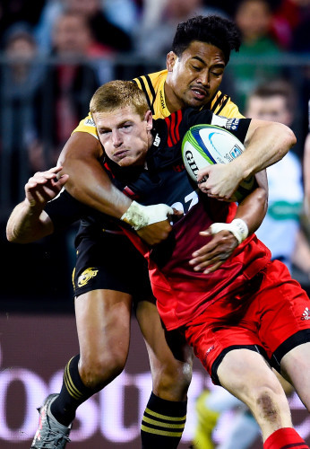 Johnny McNicholl is tackled by Julian Savea