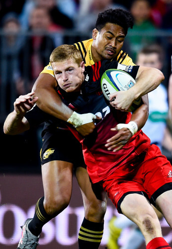 Johnny McNicholl is tackled by Julian Savea