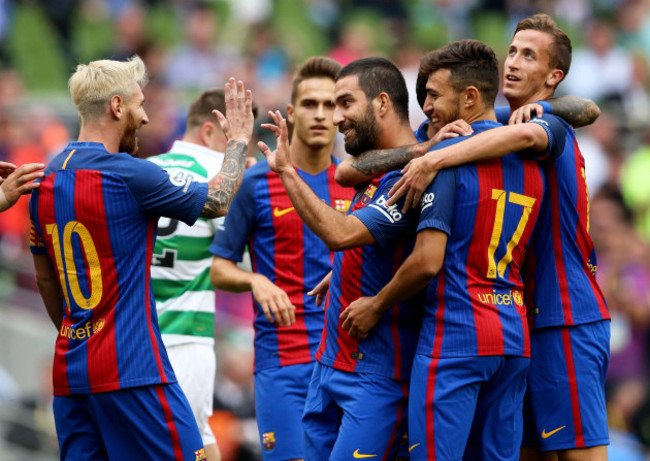 Arda Turan celebrates scoring a goal with teammates