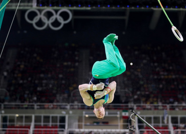 Kieran Behan dismounts from the rings