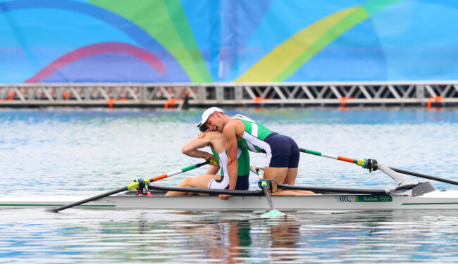 Gary and Paul O'Donovan celebrate winning silver medals